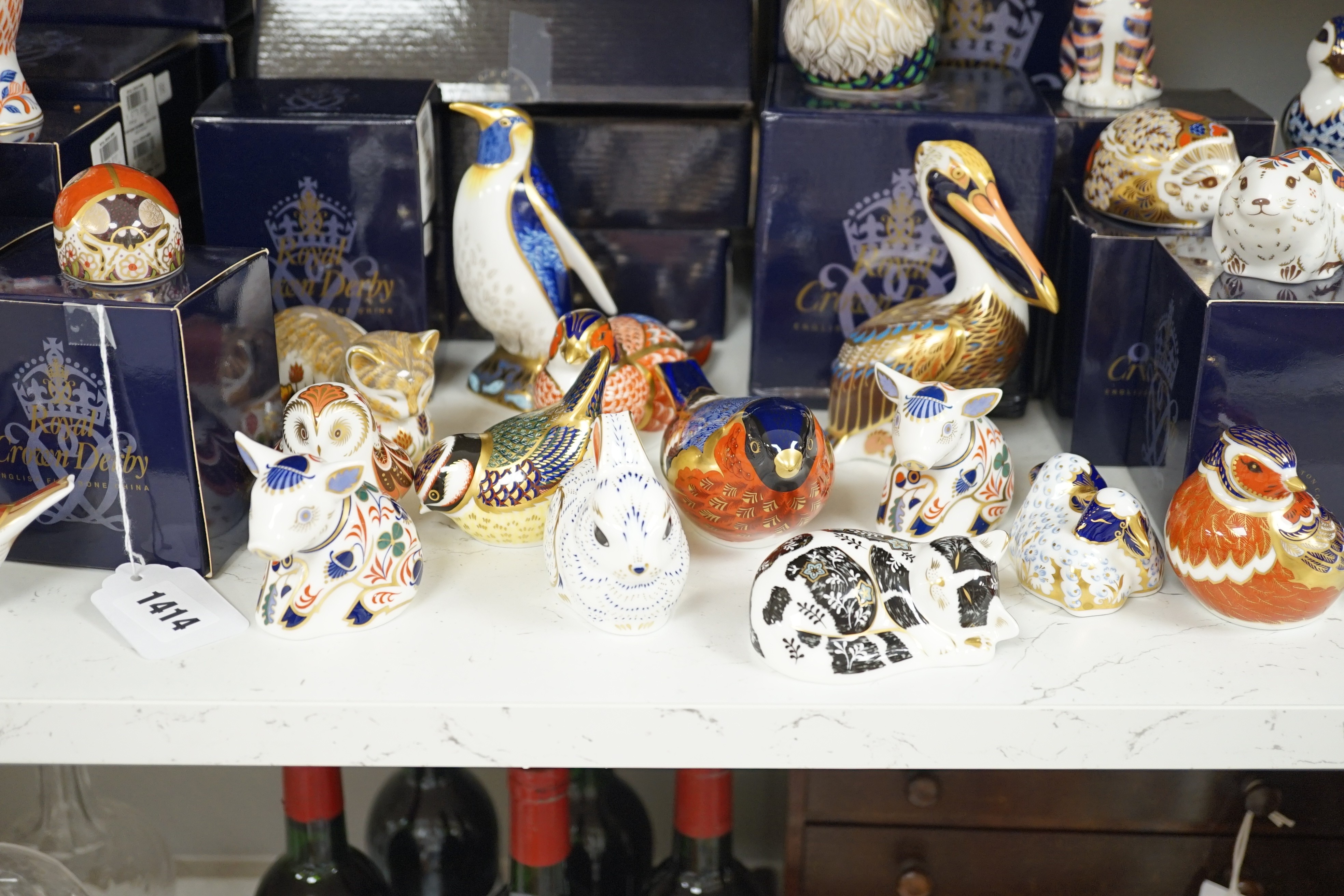 Approximately thirty-two Royal Crown Derby Imari porcelain paperweights, all but two with original boxes and mostly gold bottoms